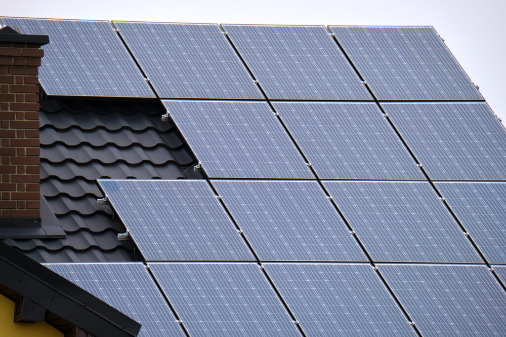 Image of the roof of a residential home, with solar photovoltaic panels installed.